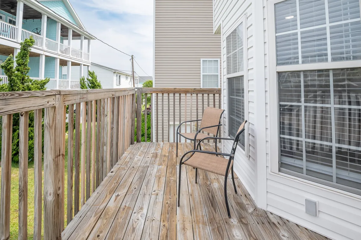 A wooden deck with two inviting chairs offers a tranquil space to enjoy morning coffee or evening breezes. The setup suggests a seamless transition between indoor comfort and outdoor adventure.